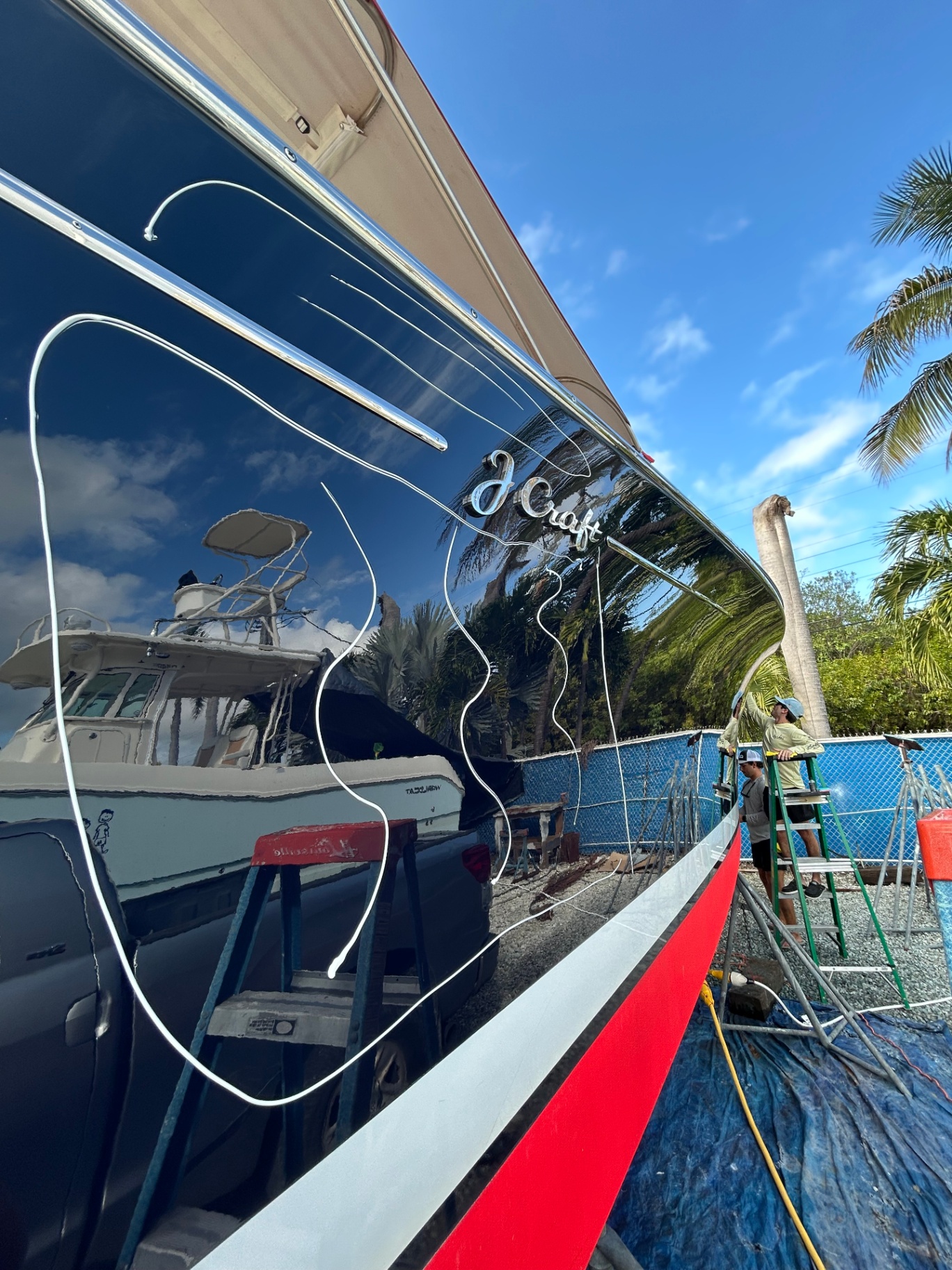 J Craft mahogany yacht with mirror-finish black hull after paint correction