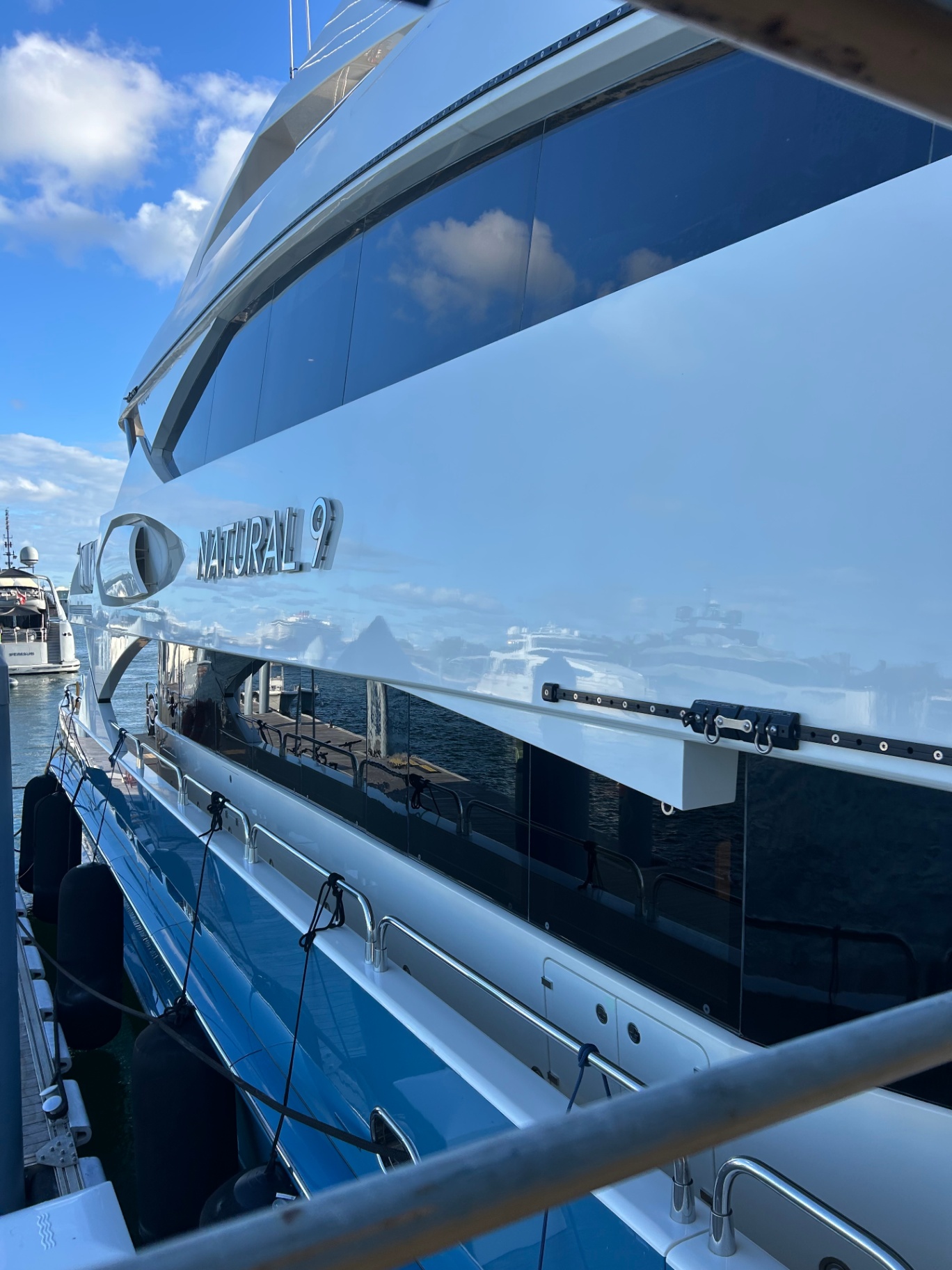 Glossy superyacht hull side detailed by AC Detailing in Miami