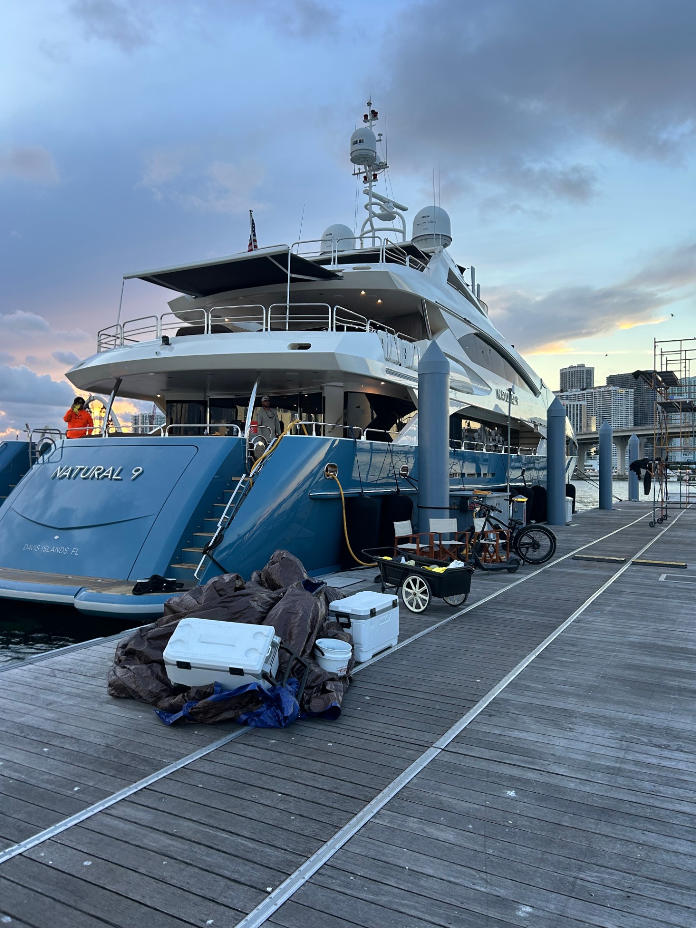 Blue-hulled motor yacht Natural 9 at sunset on Davis Islands dock